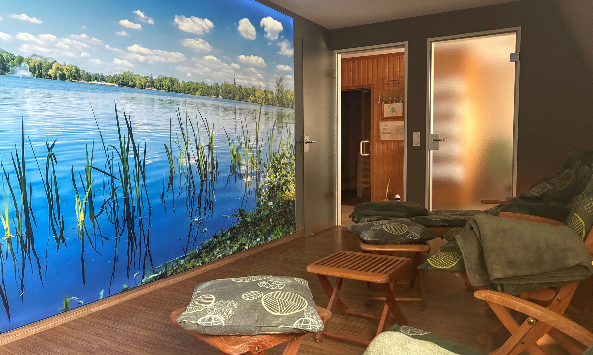 Ruheraum der Sauna mit Holzst&uuml;hlen und Liegen